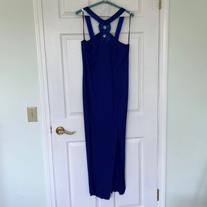 Stunning azure blue evening dress with beaded neck detail, thigh length split.